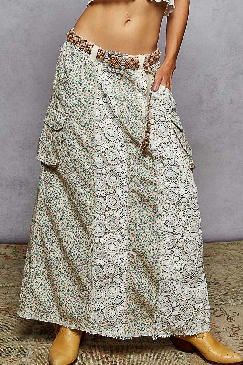 EUKALYPTO boho maxi skirt with floral print, patchwork lace details, and utility pockets. Cream and green.